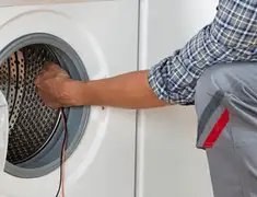 Dryer repair technician diagnosing and servicing a clothes dryer in Austin, TX