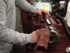 Vacuum repair technician cleaning and servicing a vacuum motor in Austin, TX